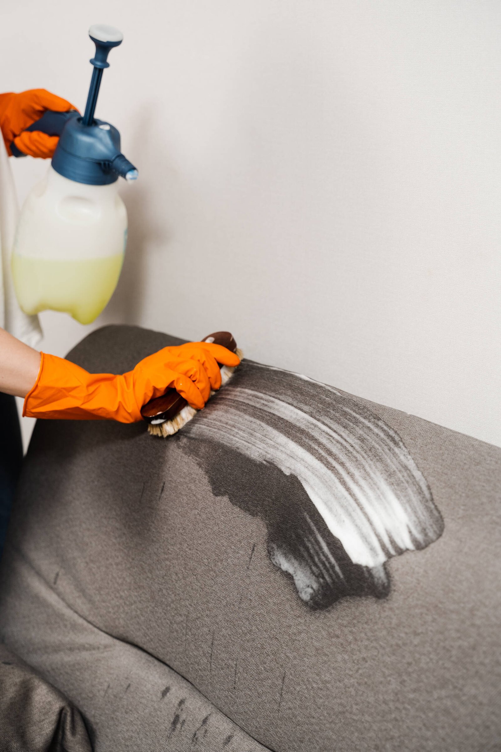 brushing-detergent-on-sofa-for-stain-removal-with-2026-04-05-00-05-03-utc